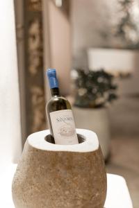 a bottle of wine sitting in a stone holder at Cydonia Caves in Megalochori