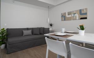 ein Wohnzimmer mit einem Sofa und einem Tisch in der Unterkunft Athens Hill Luxury Apartments in Athen