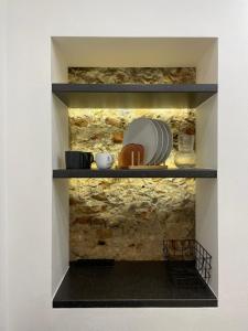 a shelf with plates and bowls on it at Oldtown apartment in Vilnius +9 photos