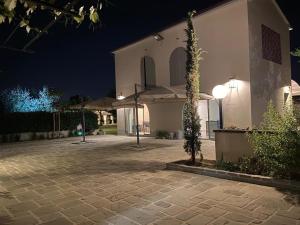 a large white building with a courtyard at night at Podere Milla in Montale