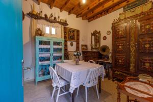 a dining room with a table and a blue cabinet at Santa Napa Guest House in Famagusta