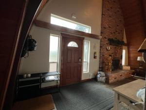 a hallway with a door and a window and a brick wall at Brian Head Cabin - 1 Mile from ALL SKI LIFTS! Cozy, Spacious & lots of fun in Brian Head