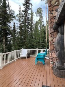 a wooden deck with a blue bench on it at Brian Head Cabin - 1 Mile from ALL SKI LIFTS! Cozy, Spacious & lots of fun in Brian Head