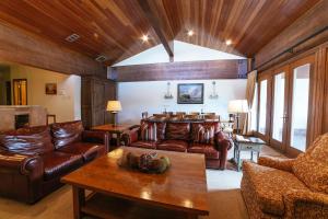 a living room with leather furniture and a table at Flagstaff Two Bedroom apartment hotel in Park City
