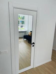 a mirror in front of a room with a couch at Oldtown apartment in Vilnius