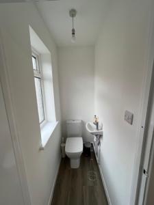 a small bathroom with a toilet and a window at Serene Property Next to Southampton General Hospital in Southampton