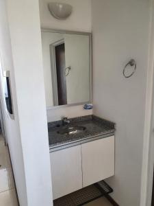 a bathroom with a sink and a mirror at Departamento Augusta in Posadas