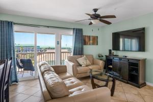 a living room with a couch and a table at St Martin Beachwalk Villas 432 in Destin
