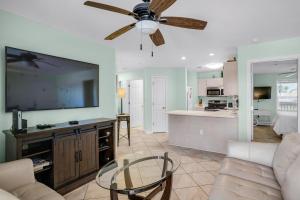 a living room with a couch and a ceiling fan at St Martin Beachwalk Villas 432 in Destin