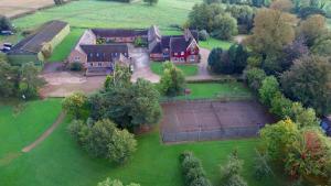 an aerial view of a house with a tennis court at Somersal Cottages in Ashbourne