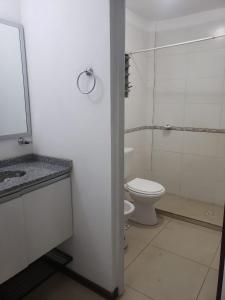 a white bathroom with a toilet and a shower at Departamento Augusta in Posadas +13 photos