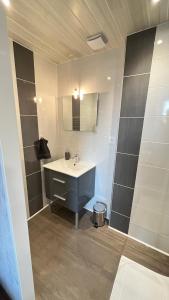 a bathroom with a sink and a mirror at Le Coeur de Pontarlier in Pontarlier