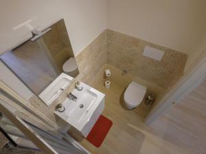 a bathroom with a sink and a toilet at Villa Rosa in Latronico