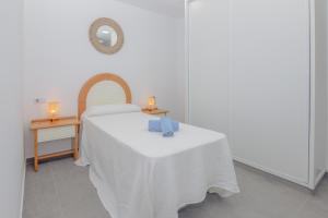 A bed or beds in a room at Poris 3 Beachfront Corralejo By Holidays Home