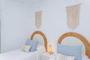 A bed or beds in a room at Poris 3 Beachfront Corralejo By Holidays Home
