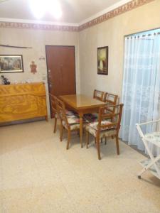 a dining room with a wooden table and chairs at depto a 50 m del casino y plaza principal "se aceptan mascotas" in Termas de Río Hondo