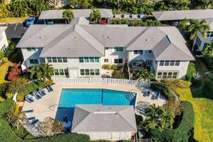 an aerial view of a house with a swimming pool at The Shore Club at Park Shore in Naples