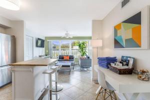 a kitchen and living room with a table and chairs at The Shore Club at Park Shore in Naples