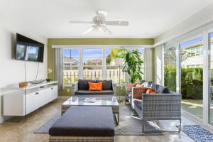 a living room filled with furniture and a ceiling fan at The Shore Club at Park Shore in Naples