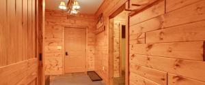 a hallway in a log cabin with a white door at Edelweiss Lodge in Boyne Falls +61 photos