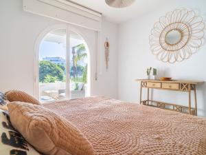 a bedroom with a bed and a table with a mirror at Gorgeous townhouse with shared pool in the middle of Marbella All yours in Marbella