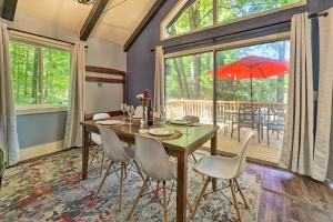 a dining room with a table and chairs and a large window at Pet-Friendly Stanwood Sanctuary with Fire Pit! in Stanwood