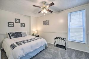 a bedroom with a bed and a ceiling fan at The Shady Cottage Millersburg Getaway with Deck in Millersburg