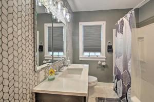 a bathroom with a sink and a toilet and a mirror at 2 Mi to Central Ave Quaint Hot Springs Home! in Hot Springs +23 photos