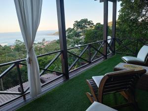 a balcony with a view of the ocean at La Roca Studio 6 in Praia do Rosa