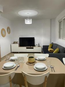 a living room with a table with chairs and a couch at UIM Mediterraneo FELIPE 8 WIFI in Puerto de Sagunto