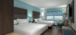a hotel room with two beds and a window at Tru By Hilton Manteca in Manteca