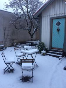 a table and chairs covered in snow in front of a building at Schwedenliebe in Frechen