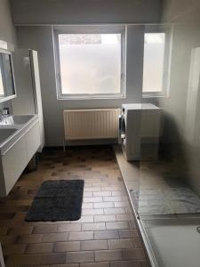 a bathroom with a sink and a microwave at Appartement224 in Grimbergen