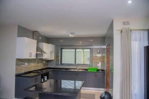 a kitchen with a sink and a counter top at Royal Suites Apartments in Lusaka