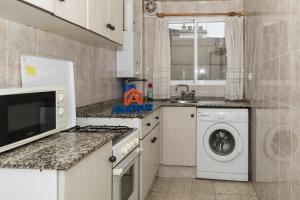 a kitchen with a washing machine and a washer at Estirpe, 4º-8 in Cullera