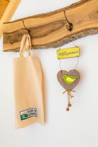 a couple of bags hanging on a wall at Vorderreithbauer in Hof bei Salzburg