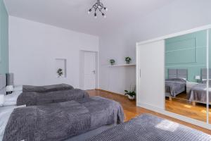 Posteľ alebo postele v izbe v ubytovaní Brzozowa Apartments by Hostly