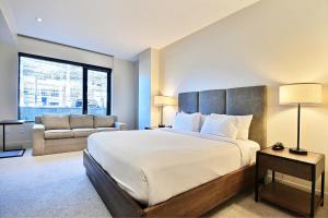 a large bedroom with a large bed and a couch at Modern Ski In Out 2 BR in Canyons Village in Park City +22 photos
