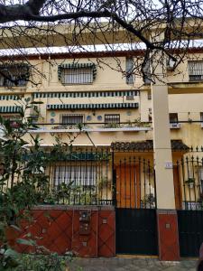 a building with orange doors and a fence at Los Jazmines, 2 in Granada