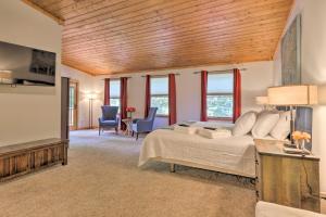 a bedroom with a bed and a living room at Secluded Leesburg Retreat with Private Hot Tub! in Middleburg