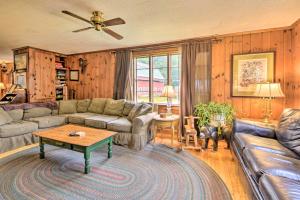 a living room with a couch and a table at Rustic Roxbury Ski Farmhouse with Trails! in Roxbury