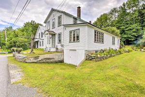 an old white house on the side of the road at Rustic Roxbury Ski Farmhouse with Trails! in Roxbury