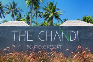 a sign for the chapelophone resort with palm trees in the background at The Chandi Boutique Resort & Spa in Senggigi