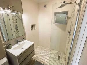 a white bathroom with a sink and a shower at ShipsBell 5B in St Francis Bay