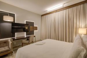 Cama ou camas em um quarto em DoubleTree by Hilton - Resort - Foz do Iguaçu
