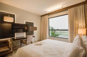 Cama ou camas em um quarto em DoubleTree by Hilton - Resort - Foz do Iguaçu