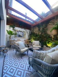 a patio with couches and chairs on a rug at Hotel Noia in Noya