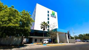 a building with a van parked in front of it at Holiday Inn Express Culiacan, an IHG Hotel in Culiacán