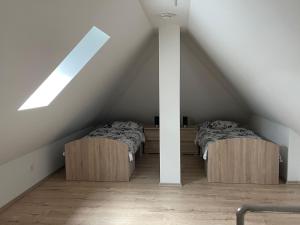 two beds in a attic room with a roof at Monteurzimmer/Ferienwohnung Brauckstraße, Gladbeck in Gladbeck