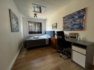 1 dormitorio con 1 cama y escritorio en una habitación en Cozy Room in the heart of Rødby! 5km from Femern & Puttgarden! en Rødby